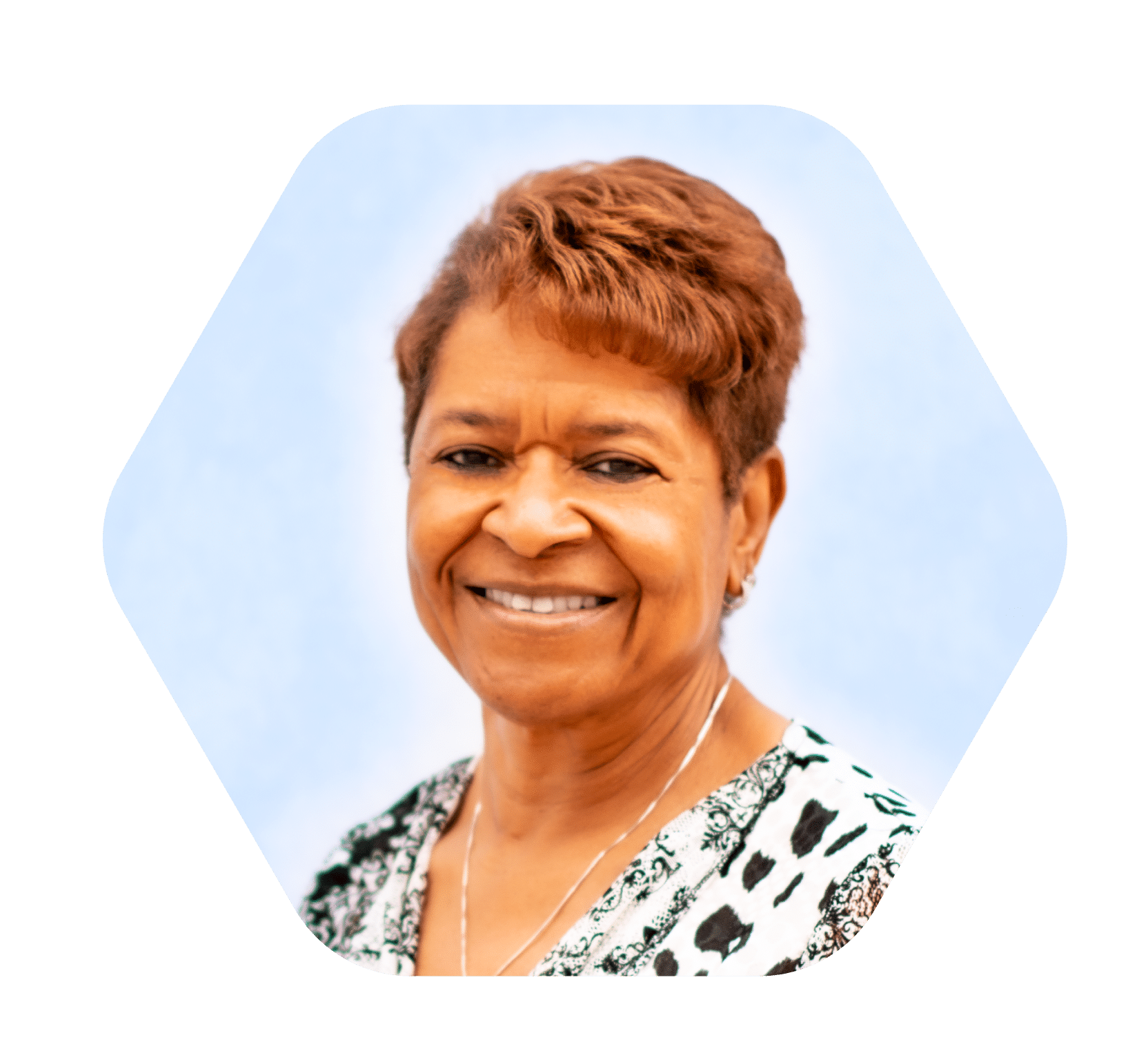 close up headshot of middle aged woman smiling with short hair and light blue and white background