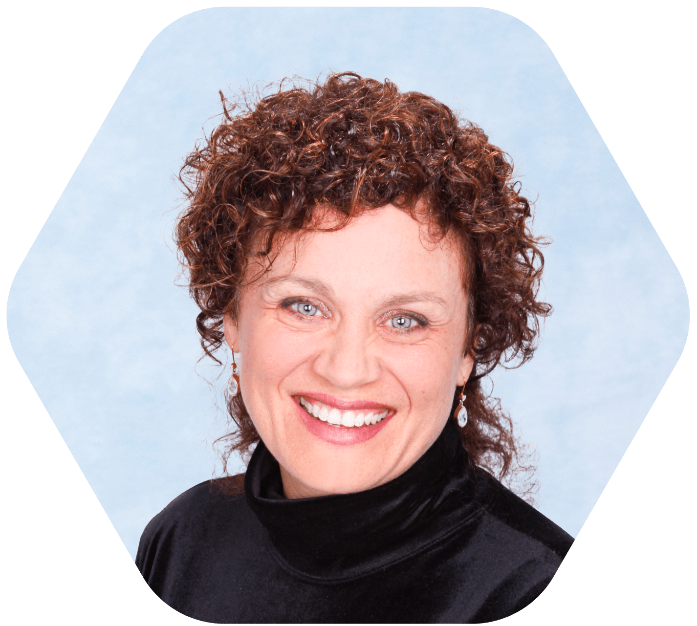 headshot of middle aged woman with curly hair in black smiling with light blue and white background