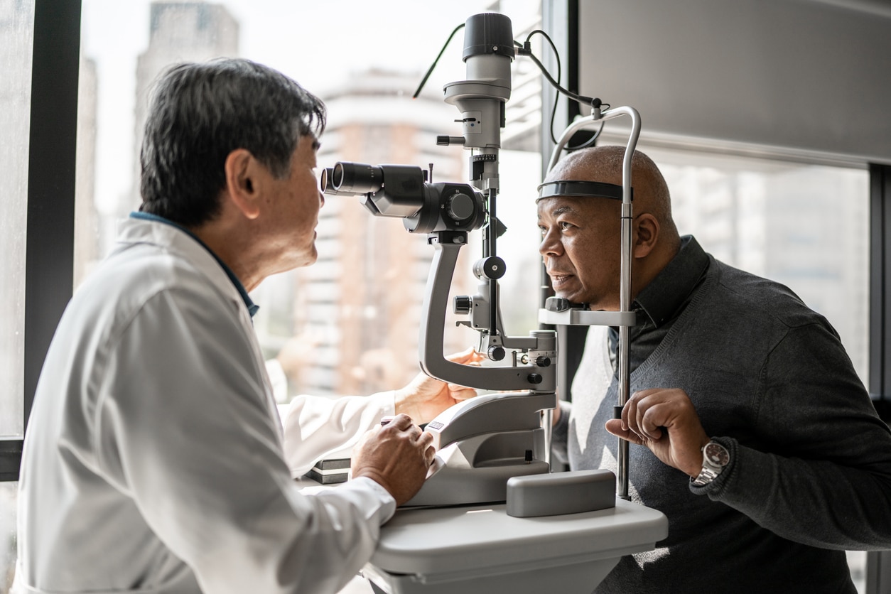Woman pulling at her eyelid skin Man undergoing a slit-lamp eye examination to check for diabetic retinopathy and other diabetes-related eye changes.